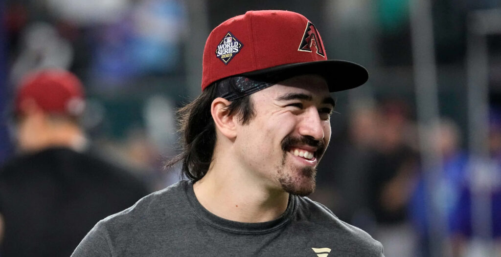 Corbin Carroll smiling wearing Arizona Diamondbacks cap dark t-shirt vibrant baseball player wallpaper