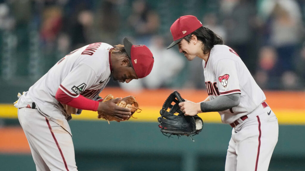 Corbin Carroll celebrating with teammate in Arizona Diamondbacks uniforms dynamic baseball action wallpaper