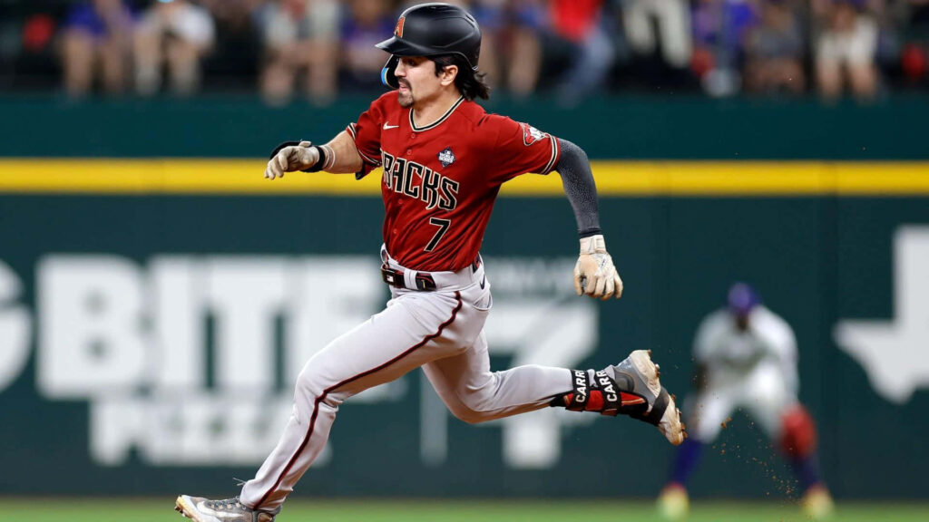 Corbin Carroll sprinting in red Arizona Diamondbacks jersey dynamic baseball action wallpaper