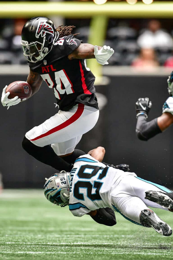 Cordarrelle Patterson leaping high evading tackle in Atlanta Falcons uniform NFL action wallpaper