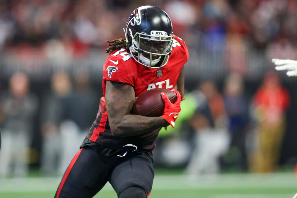 Cordarrelle Patterson Atlanta Falcons in red black uniform powering forward with football NFL action Wallpaper