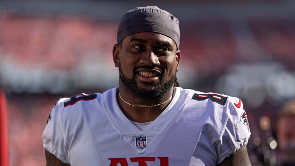 Cordarrelle Patterson Atlanta Falcons smiling in jersey vibrant stadium lights blurred crowd wallpaper