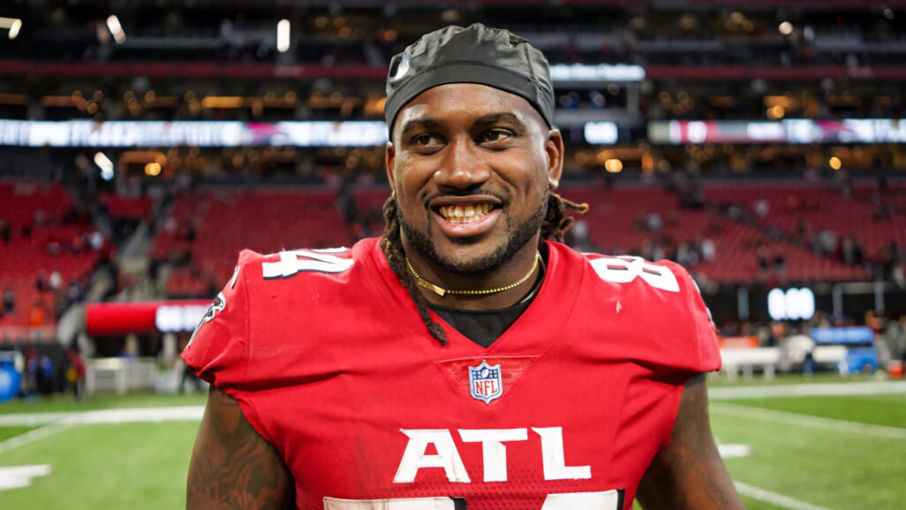 Cordarrelle Patterson smiling on field in red Atlanta Falcons jersey number 84 stadium lights Wallpaper