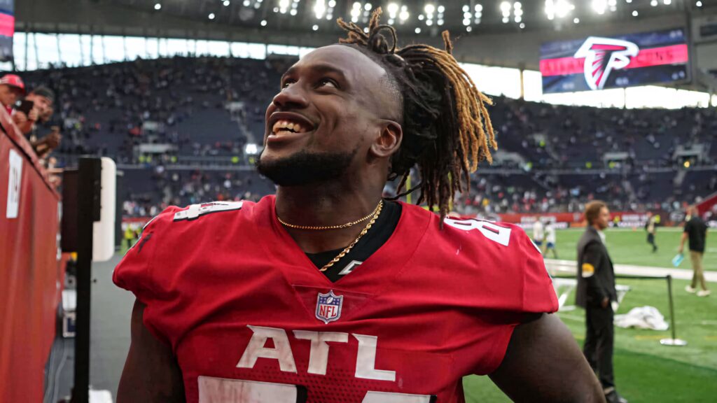 Cordarrelle Patterson smiling in Atlanta Falcons uniform on field with vibrant stadium fans Wallpaper
