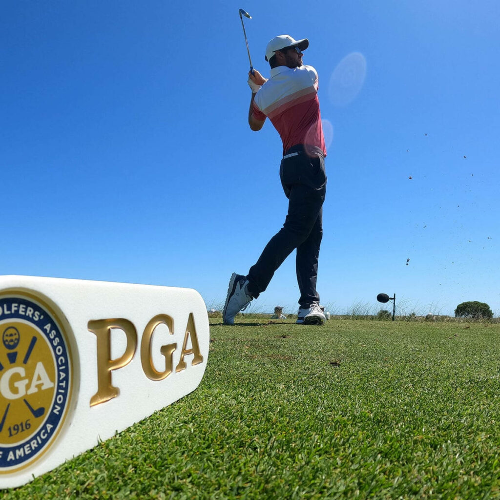 Corey Conners' Golf Swing Under Clear Blue Sky - Wallpaper Background