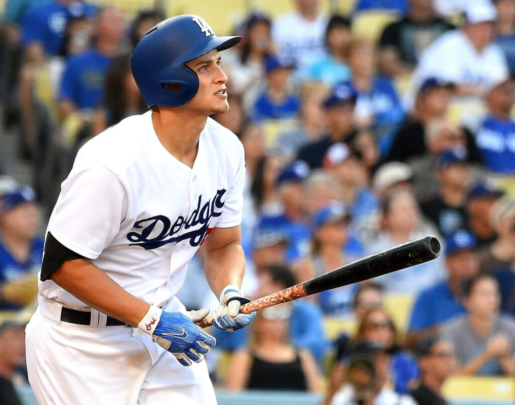Corey Seager in Los Angeles Dodgers uniform gripping bat with focused crowd in stadium background Wallpaper