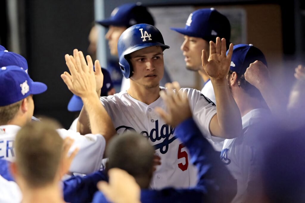 Corey Seager Dodgers celebrating in dugout high fives bright lighting team spirit wallpaper