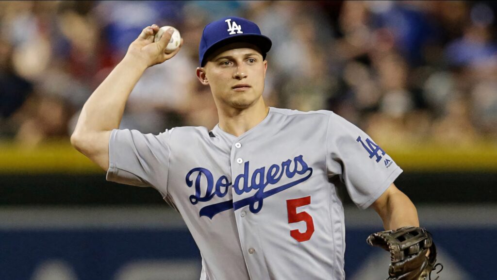 Corey Seager throwing baseball in Los Angeles Dodgers uniform with blurred stadium background Wallpaper