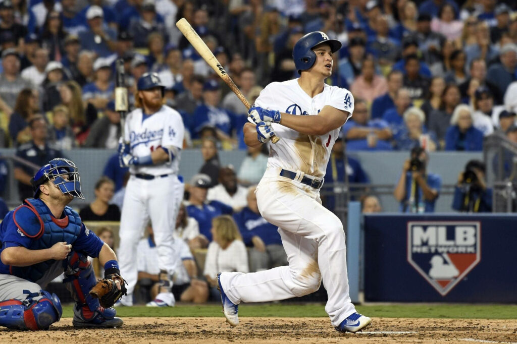 Corey Seager mid-swing in sunlit stadium baseball wallpaper showing focus and intensity