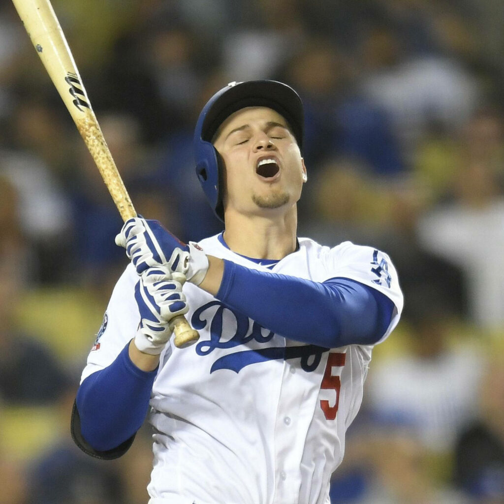 Corey Seager in Dodgers uniform swinging bat intense focused baseball action wallpaper background