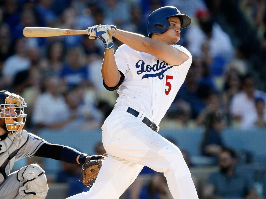 Corey Seager Dodgers mid-swing vibrant baseball action with focused expression and stadium background Wallpaper