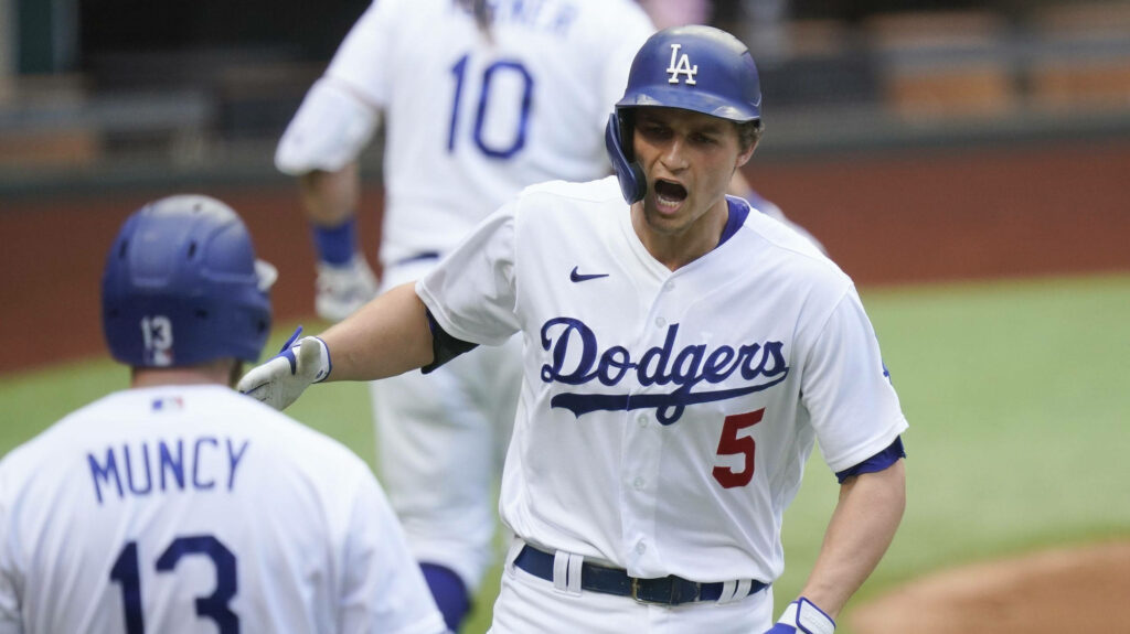 Corey Seager and Max Muncy Dodgers celebrating on field in white and blue uniforms wallpaper