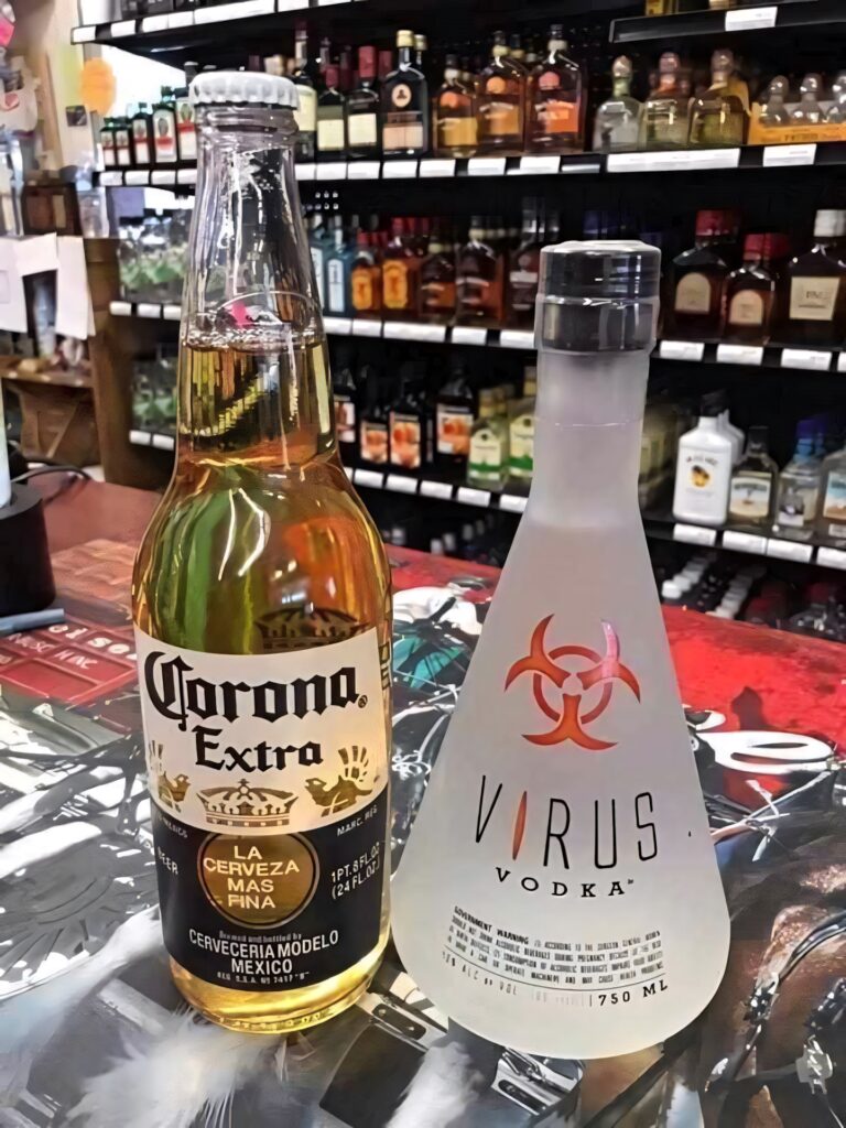 Corona Extra beer and Virus Vodka bottles side by side on store counter with liquor background Wallpaper