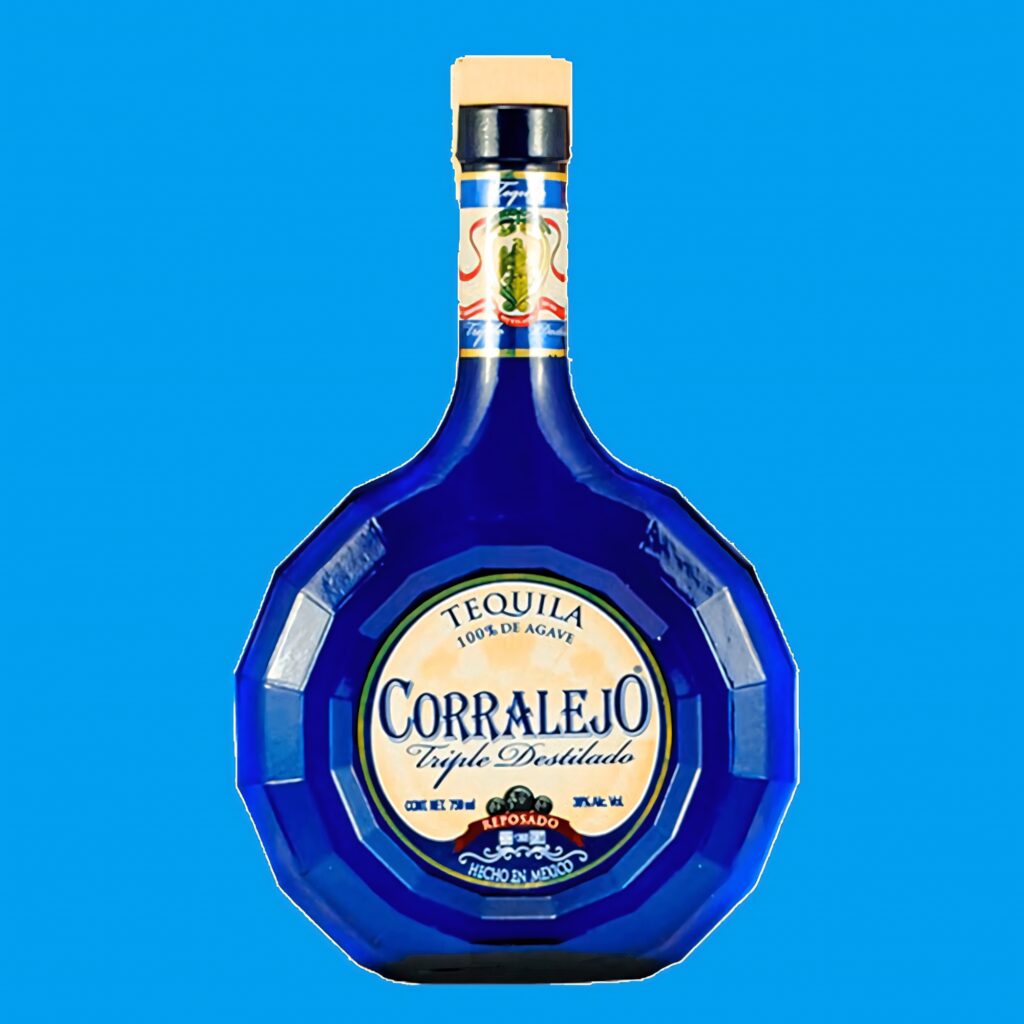 Vibrant blue Corralejo Reposado Tequila triple distilled faceted bottle on solid blue background Wallpaper