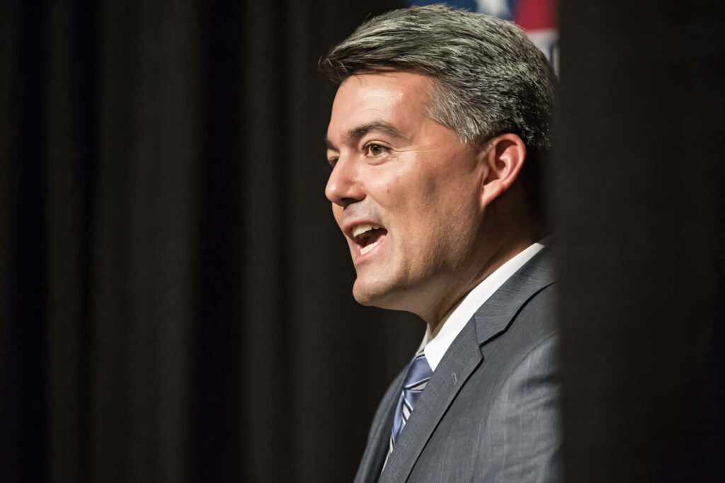 Cory Gardner profile portrait in formal attire with dark background professional business wallpaper