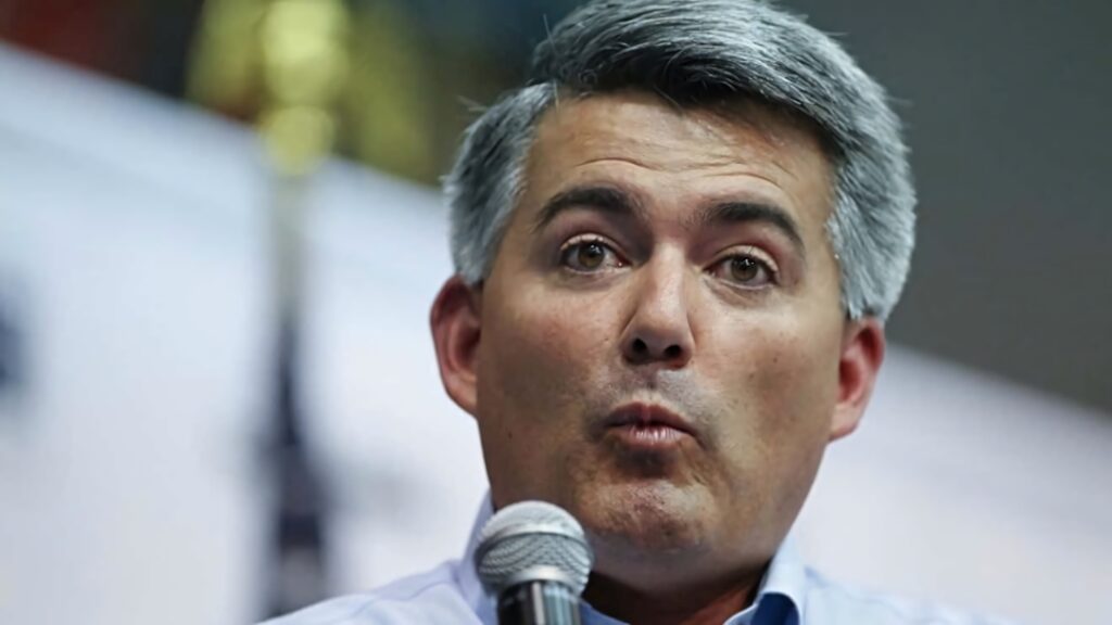 Cory Gardner speaking into microphone sharp focus natural lighting neutral background wallpaper