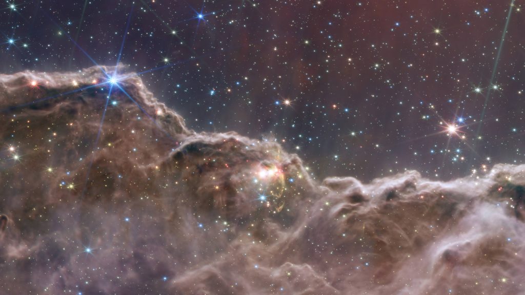 Stunning 4K view of Carina Nebula Cosmic Cliffs with star-lit skies and gaseous dust clouds Wallpaper