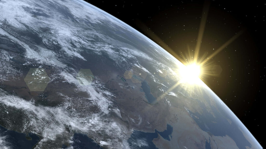 Spectacular Earth from space, sun illuminating the planet amidst dazzling stars - cosmic wallpaper.
