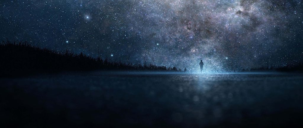 Silhouette running beneath vibrant starry galaxy sky with deep blue cosmic digital art wallpaper