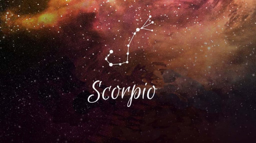 Cosmic Scorpio wallpaper with zodiac constellation over deep red nebula and cursive typography