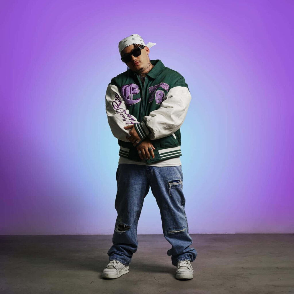 Costa Titch in green varsity jacket blue jeans sunglasses bandana purple background urban style Wallpaper