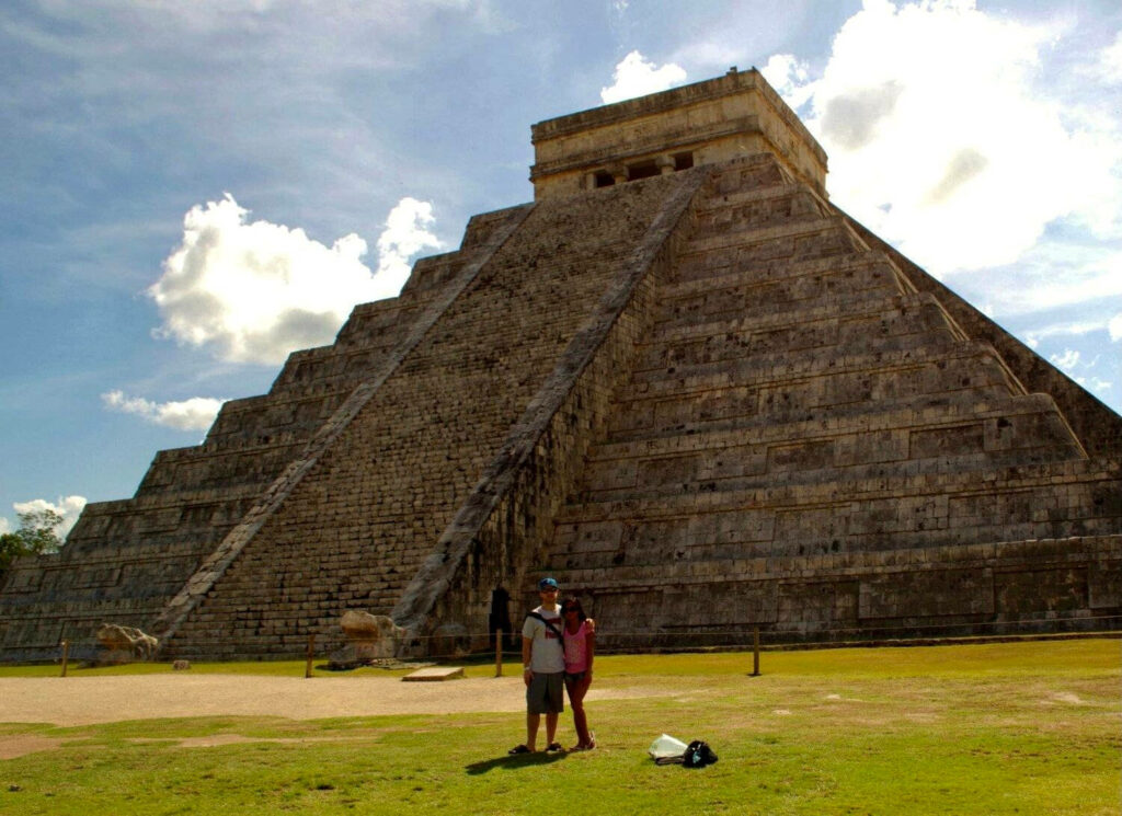 Couple at Chichen Itza: Stunning Mayan Pyramid Wallpaper Background