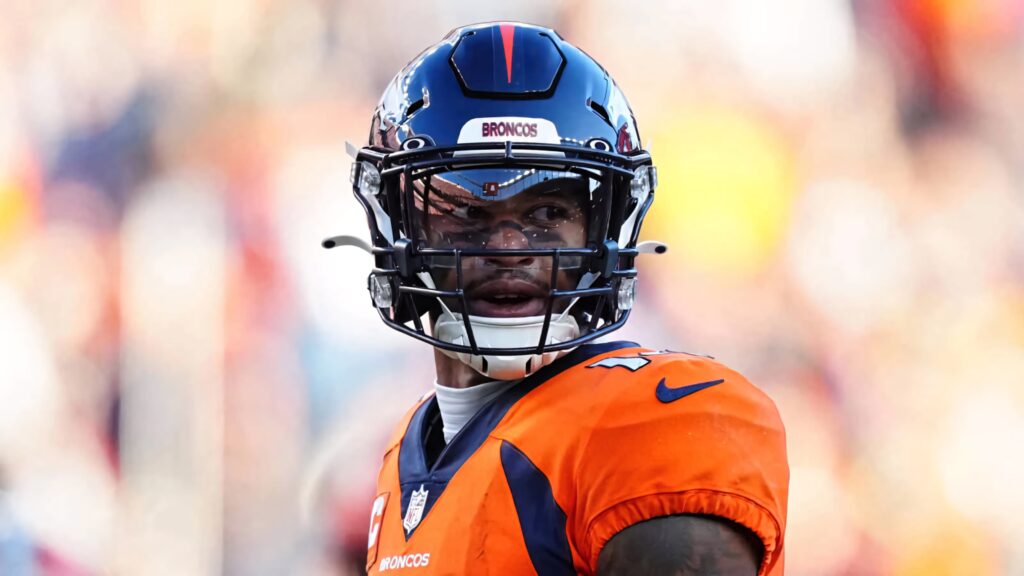 Denver Broncos Courtland Sutton in orange uniform focused during intense NFL game action wallpaper