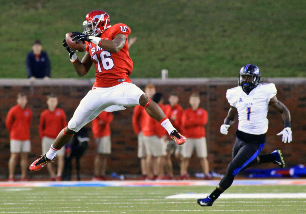 Courtland Sutton making dynamic football catch in red white gear on green field mid-game action Wallpaper