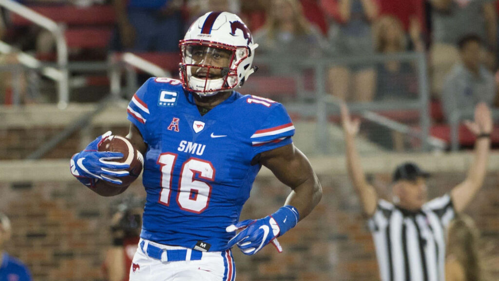 Courtland Sutton sprinting in blue SMU football uniform during intense college game action Wallpaper