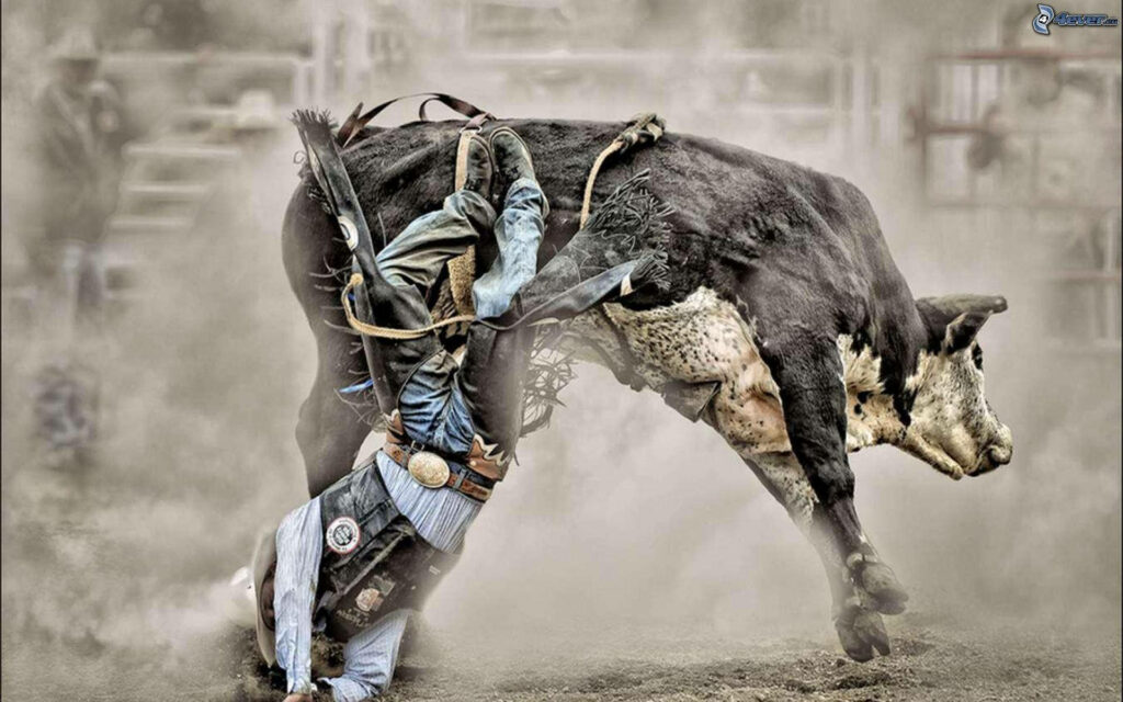 Cowboy mid-fall from bull in dusty rodeo arena dynamic wallpaper background adrenaline ride