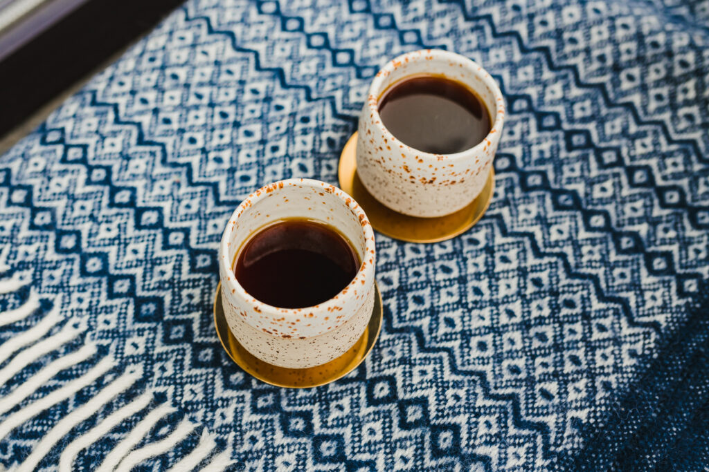 Cozy Aesthetic Wallpaper: Ceramic Cups on Blue Fabric Background