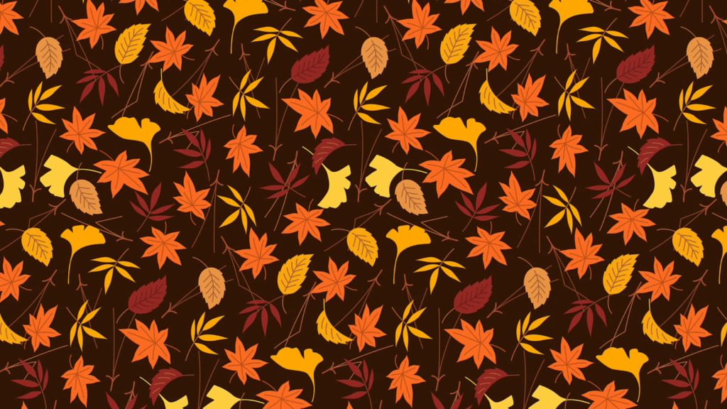 Cozy autumn wallpaper with vibrant maple and ginkgo leaves on a dark brown background