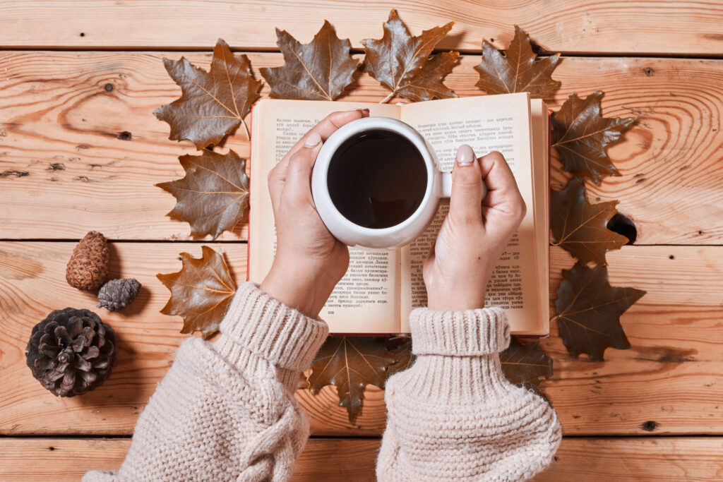Cozy Autumn Vibes: Coffee, Books, and Leaves Wallpaper Background