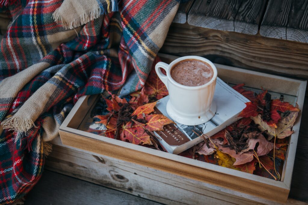 Cozy Autumn Cocoa Setup with Leaves, Book & Plaid Wallpaper