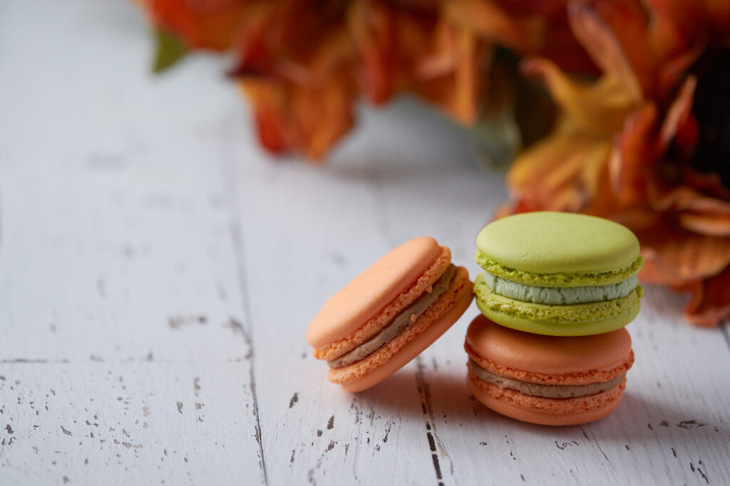 Cozy Autumn Wallpaper: Colorful Macarons on Rustic Wood