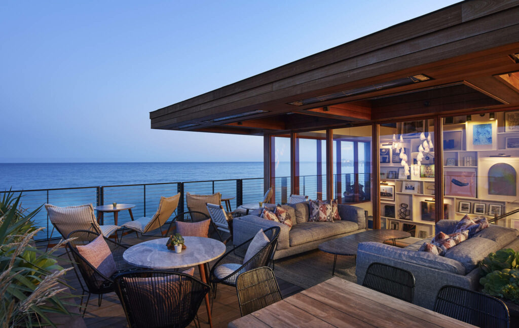 Cozy Beach House Deck: Serene Ocean Views & Modern Rustic Design Wallpaper