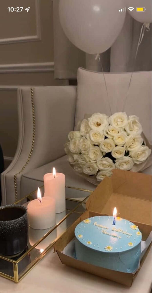 Cozy Birthday Celebration: Blue Cake, Candles & Elegant Roses Wallpaper