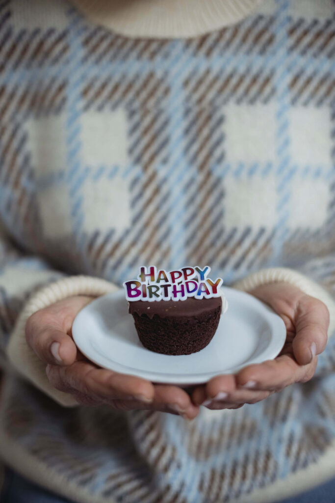 Cozy Birthday Treat: Chocolate Cupcake with Colorful Decorations Wallpaper