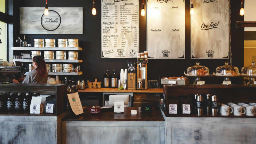 Cozy Blind Tiger Coffee Roasters interior with rustic counter menu boards and warm pendant lights Wallpaper