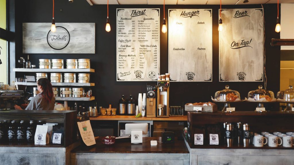 Cozy Blind Tiger coffee shop interior with rustic menu boards and artisanal coffee canisters wallpaper