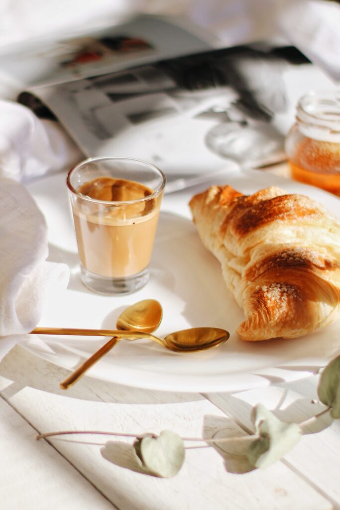 Cozy Breakfast Setup: Crispy Croissant, Creamy Coffee & Honey Delight Wallpaper