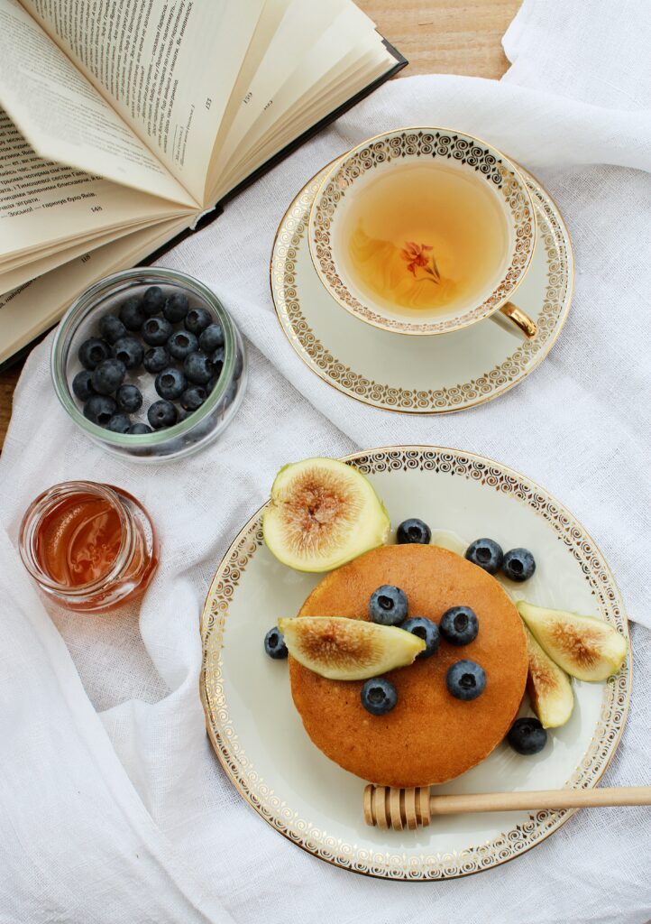 Cozy Breakfast Setup with Pancakes, Figs, Blueberries & Tea Wallpaper