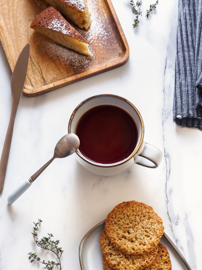 “Cozy Breakfast Setup: Tea, Cookies & Pie on Marble Table Wallpaper”