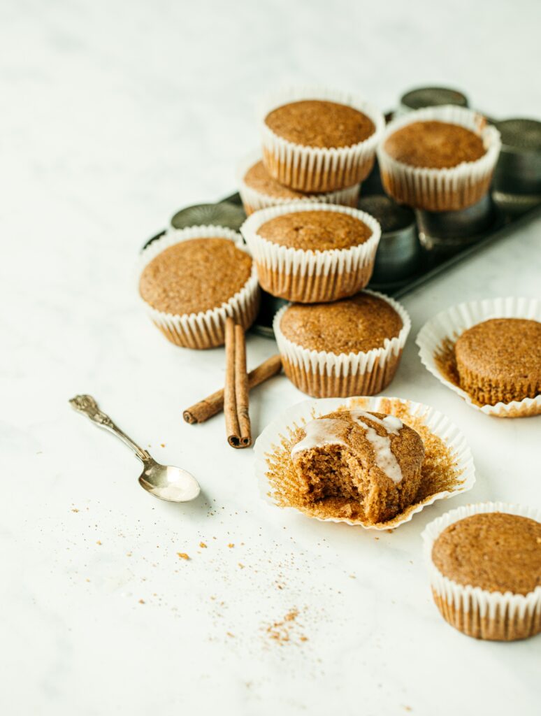 Cozy Cinnamon Muffins Display with Powdered Sugar & Rustic Sticks Wallpaper