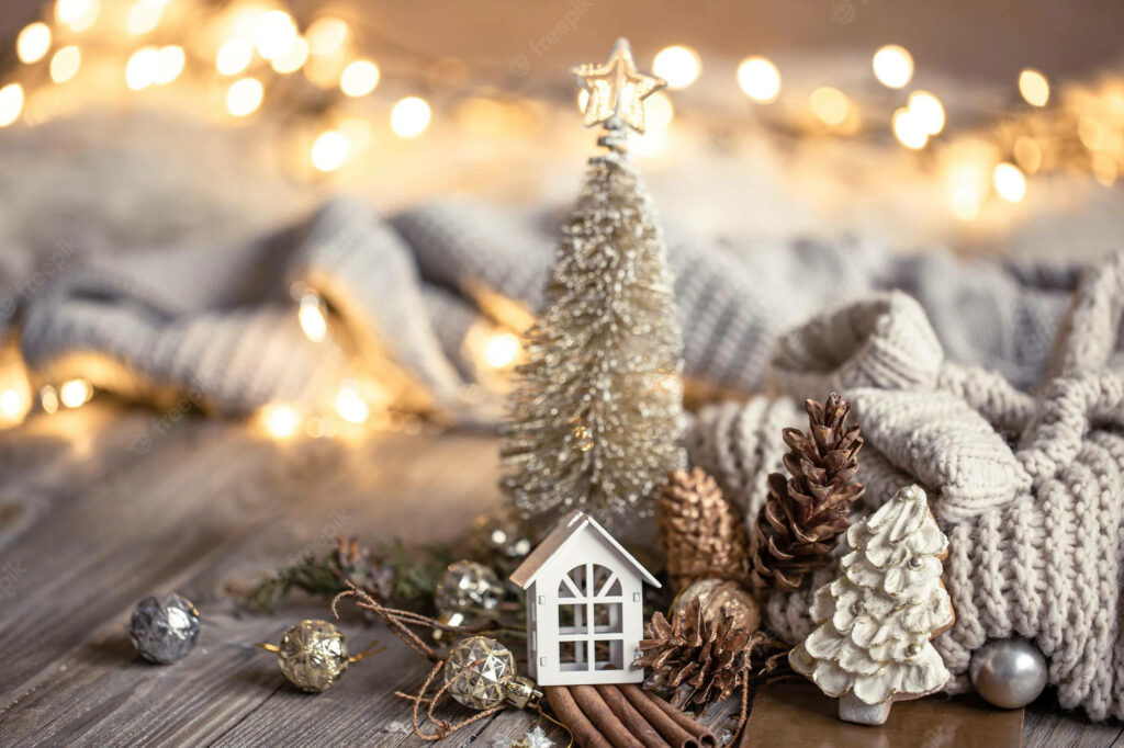 Cozy Rustic Vibes: Miniature Wooden Cottage, Mini Tree, Acorns, and Holiday Ornaments on a Festive Desktop Wallpaper
