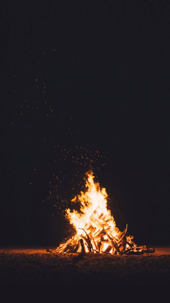 Vibrant flickering campfire mobile wallpaper on deep black perfect for AMOLED screens and devices