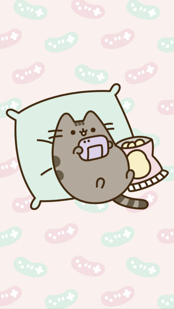 Purrfectly Content: Adorable Kawaii Cat Blissfully Engrossed in Gadget Play on its Pillow Wallpaper