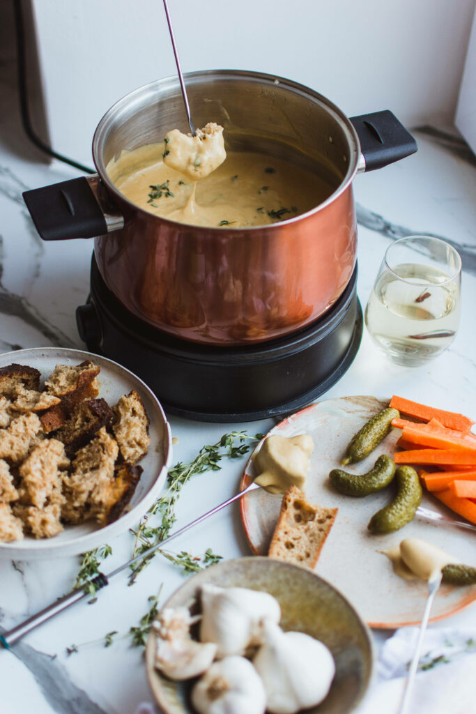 Cozy Fondue Setup: Warm Cheese & Delicious Sides - Wallpaper Background