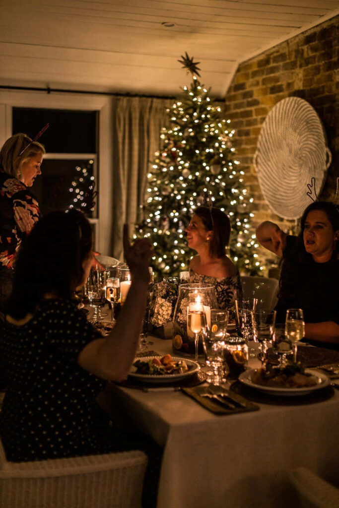 Cozy Christmas Dinner with Twinkling Tree & Festive Atmosphere Wallpaper