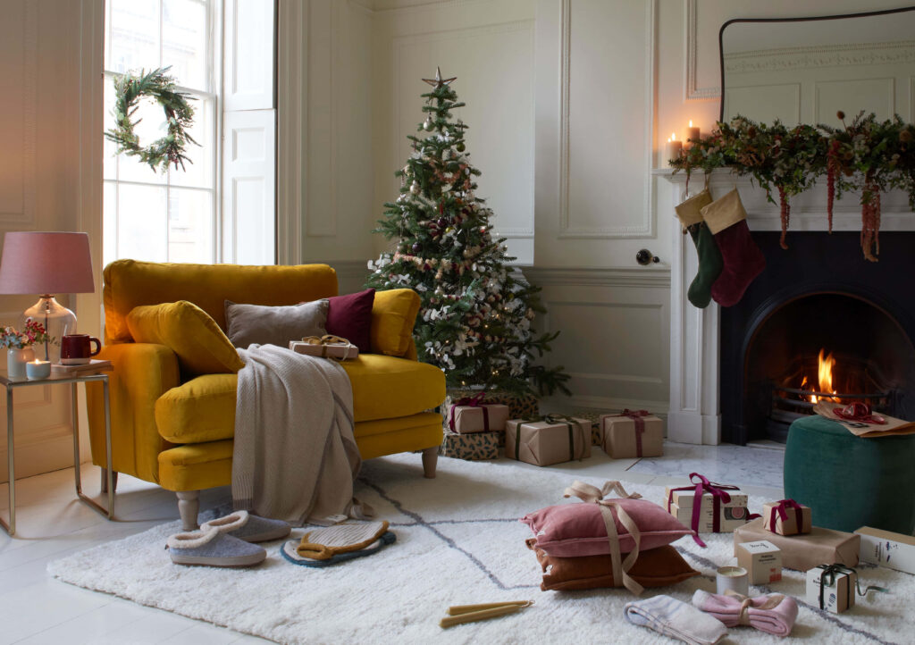 Cozy Christmas Living Room With Tree, Stockings, and Gifts Decor Wallpaper